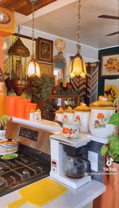 a kitchen filled with pots and pans next to a stove top oven on a counter