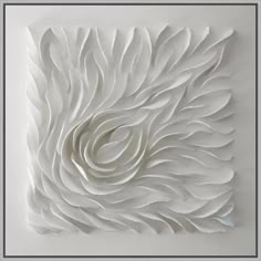 a white wall sculpture made out of paper