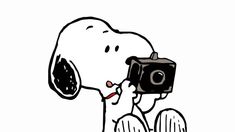 a person holding a camera up to their face while taking a picture with a dog