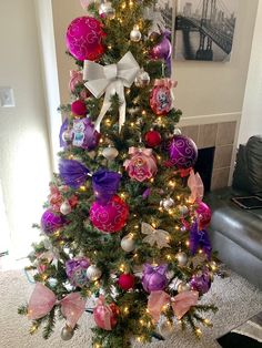 a decorated christmas tree with pink and purple ornaments