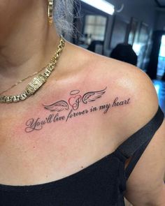 a woman with a tattoo on her chest saying you'll love forever in my heart