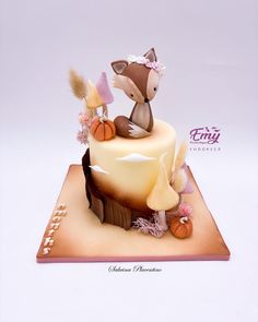 a cake decorated with an image of a fox and other animals on top of it