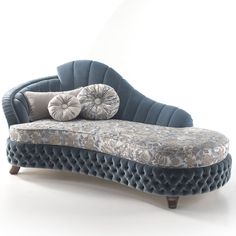 a blue couch with two pillows on it's back and one pillow on top