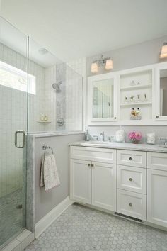 an image of a bathroom with white cabinets and tile flooring on the phone screen