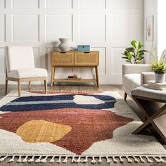 a living room area with a rug, chair and coffee table on the hardwood floor