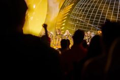 a group of people standing on top of a stage next to a giant yellow banana