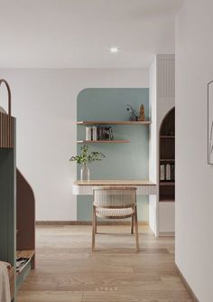 a room with a desk and shelves on the wall, next to a book shelf