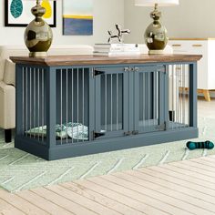 a living room with a dog crate on the floor