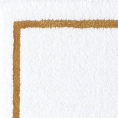 a white rug with a brown border on the top and bottom corner, in front of a white background