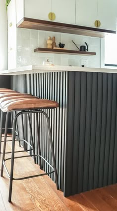 the bar stools are next to the counter in the kitchen