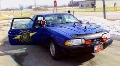 a police car is parked on the side of the road