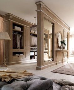 a large closet with mirrors and clothes on the walls