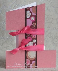 a pink and brown card with ribbon on it