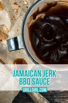 a bowl filled with barbecue sauce on top of a wooden table