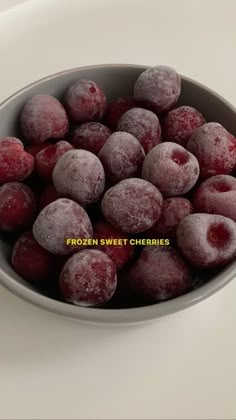 frozen sweet cherries in a bowl on a white counter top with the words frozen sweet cherries