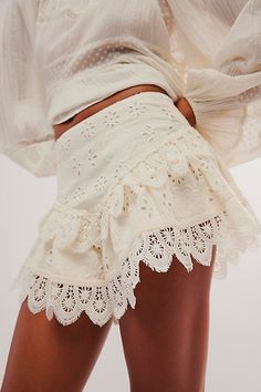 Forever femme with delicate detailing, these sweets shorts from our Bali collection will turn heads with every wear. **Fit:** Mid-rise, dropped tiered silhouette **Features:** Elastic waistband for pull-on ease, dropped basque waist, eyelet lace detailing, scalloped trimming **Why We ❤ It:** Timeless with western boots or off-duty with sporty sneakers, this pair has endless ways to wear. | Bali Warm Nights Embroided Shorts at Free People in White, Size: S Bohemian Shorts With Ruffles, Chic Lace Trim Shorts For Spring, Feminine Tiered Ruffled Skirt Shorts, Chic Spring Shorts With Lace Trim, Bohemian Ruffled Shorts For Spring, Bohemian Cream Ruffled Skirt Bottoms, Chic Tiered Skirt Shorts For Brunch, Bohemian Ruffled Shorts For Summer, Summer Bohemian Ruffled Shorts