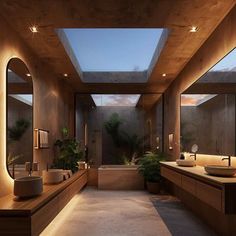 a large bathroom with two sinks, mirrors and lights on the ceiling is lit up by recessed lighting