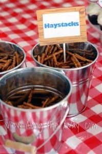 three tins filled with food sitting on top of a red and white checkered table cloth