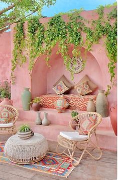 an outdoor area with wicker furniture and potted plants