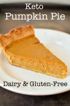 a slice of pumpkin pie on a white plate with a black table in the background