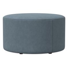 a large round ottoman that is blue