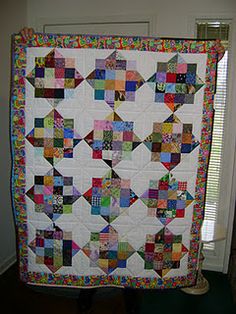 a large quilt hanging from the side of a door