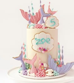 there is a cake decorated with mermaid decorations