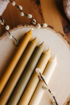 several candles are arranged on a wooden stand