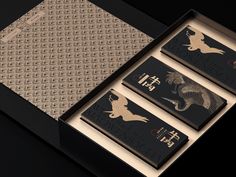 three business cards in a black box with gold foil on the front and back side