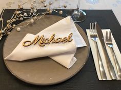 a place setting with silverware and napkins