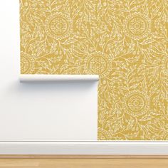 an empty room with yellow wallpaper and white trim