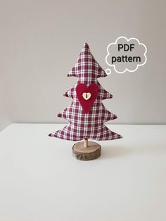 a red and white checkered christmas tree with a heart on it's head