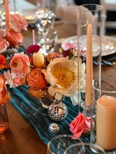 the table is set with candles, flowers and other items for an elegant dinner party