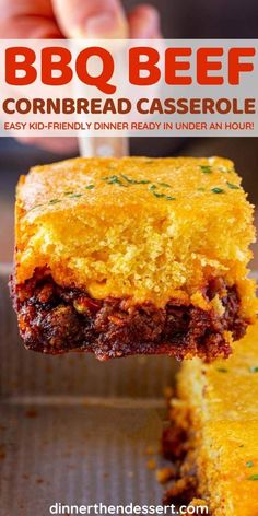 a person holding up a piece of cornbread casserole with meat in it