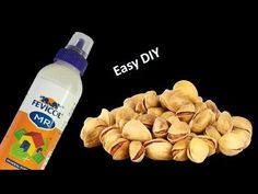 a bottle of water and some nuts on a black background with the words easy diy next to it