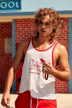 a young man in red shorts holding a frisbee