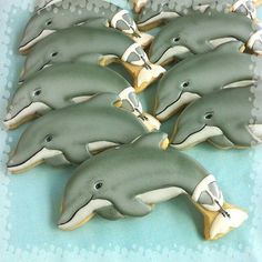 some dolphins are sitting in the middle of a row on a blue tablecloth with white dots