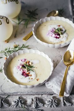 two bowls filled with soup on top of a table