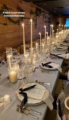 a long table is set with candles and place settings