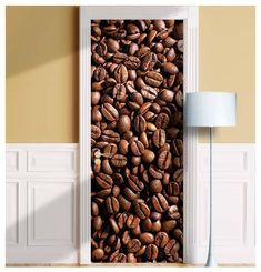 an open door with coffee beans printed on it and a lamp next to the door