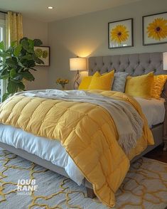 a bedroom with yellow and gray bedding, windows, rugs and pictures on the wall