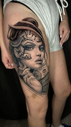 a woman's thigh with a clock on it and her face painted in black ink