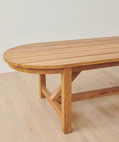 an oval wooden table sitting on top of a hard wood floor