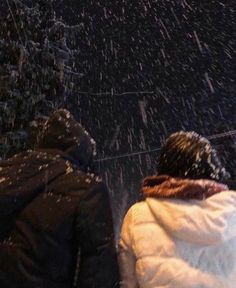 two people walking in the snow with an umbrella