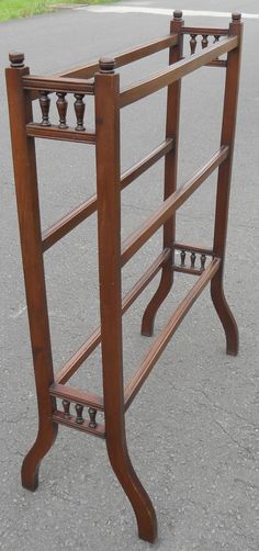 an old wooden rack is sitting in the middle of the street with two candles on it