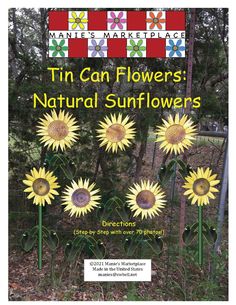 a poster with sunflowers on it in front of some trees and bushes,