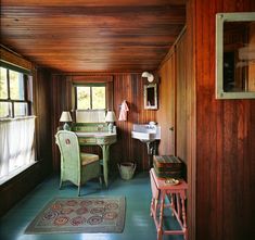 a room with wooden walls and green flooring