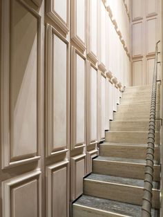 a set of stairs leading up to the second floor in a building with white walls