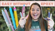 a woman holding up six different colored pens in front of her face with the words easy without epoxy on it