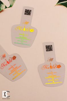 three luggage tags with qr code printed on them and palm leaves in the background